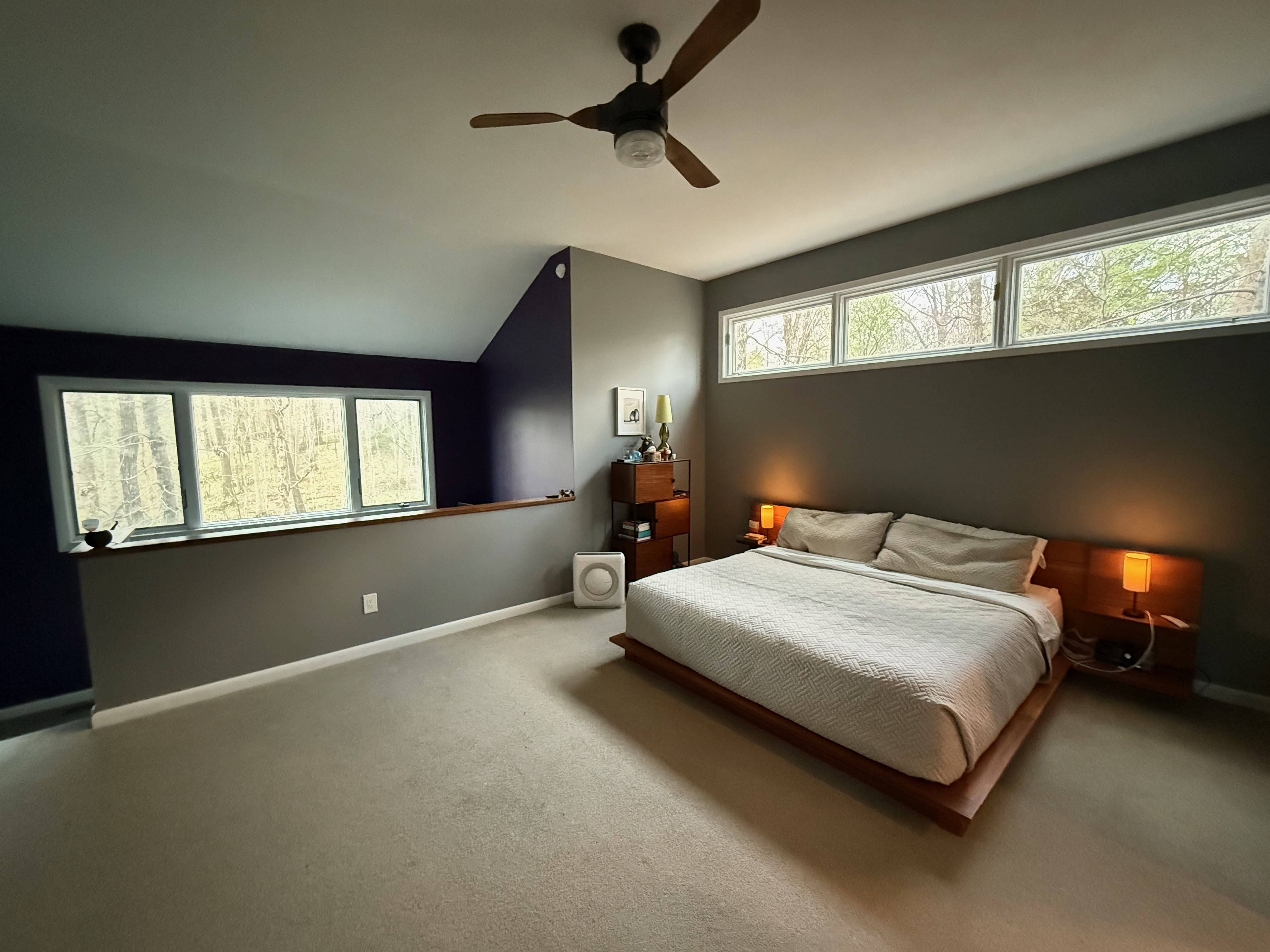 Primary bedroom with king bed and wooded views